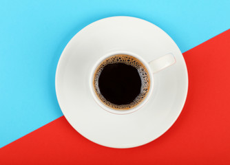 Full white espresso coffee cup on red and blue