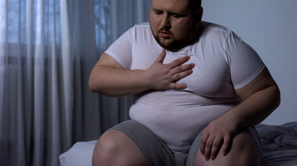 Overweight man feeling chest pain, health body care, heart attack, dyspnea