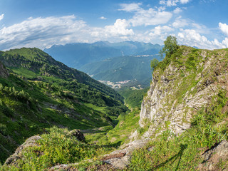 View from the top of the aibga Ridge at the Rosa Khutor ski resort, surrounded by high mountains.