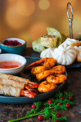 Giant king prawns and selection of mini Chinese dumplings with sweet chili dipping sauce. Party food idea.