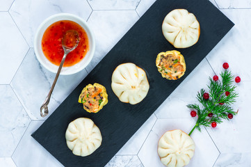 Selection of mini Chinese dumplings - dim sum with sweet chili dipping sauce. Party food idea. Top view.