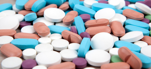many multi-colored medical pills close up