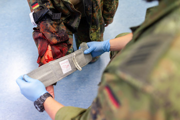 Paramedic soldier creates a bandage on a make up fracture