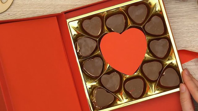 Woman Open Gift Box With Heart-shaped Chocolate Candies Aphrodisiac, Top View