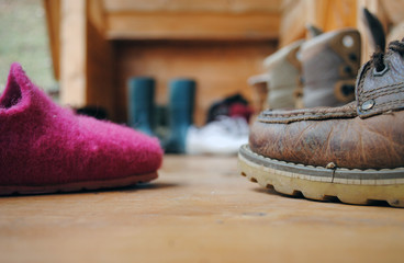Men's and women's shoes are on the doorstep of a village house