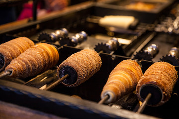 Preparation of the traditional Trdelník a kind of spit cake made from rolled dough wrapped around...