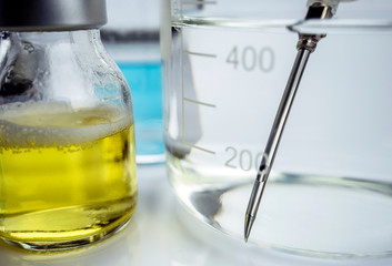 Needle inside precipitation glass along with roads in a hospital, conceptual image