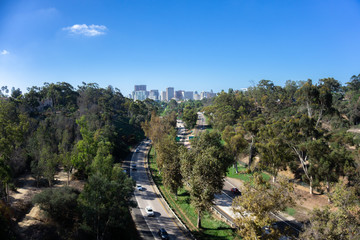Fototapeta premium Freeway road to the city and out of the city among trees