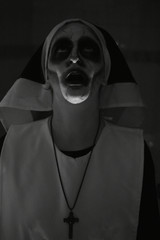Terrifying face of nun on Halloween night. Nun of evil. Murder nun.