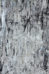 Wooden background with traces of old black paint.