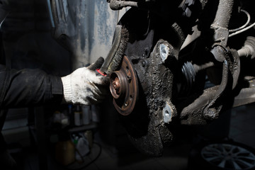 Fototapeta na wymiar A mechanic working on a brake pad