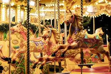 Fototapeta na wymiar Three gold horse on merry-go-around ride