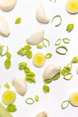 top view of sliced onions and scallions on white studio background. garlic vegetables. 