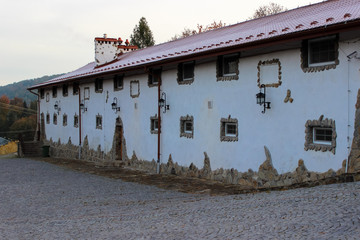 Typical village house with small windows covered with stones