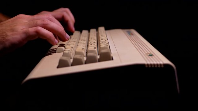 Typing on old computer in a dark room