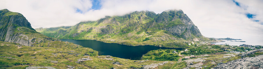 Panoramic view of Å i Lofoten, Norway, famous traditional fishing village and popular tourist attraction. Lake between mountains.