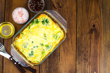 Omelette of eggs, broccoli, cheese in glass heat-resistant form, baked in oven