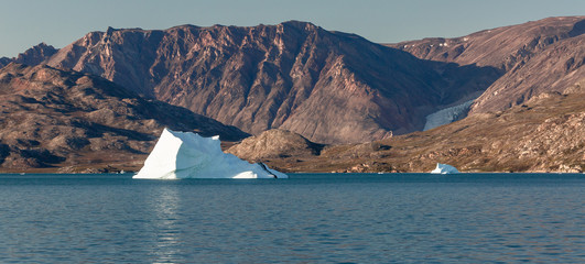 arctic landscape with icebergs among east Greenland fjords
