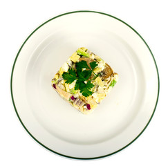 Salad with chicken and avocado on plate isolated on white background