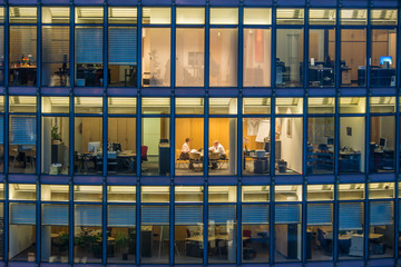 skyscraper Office windows and office worker by night