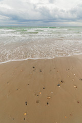 View of the sea from the beach under a stormy sky