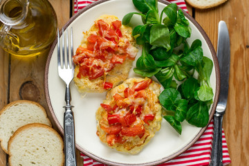 Oven baked chicken breasts topped with tomatoes and bell peppers