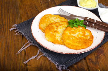 Vegetable rosti, golden fried potato pancakes with dips from cauliflower and sour cream