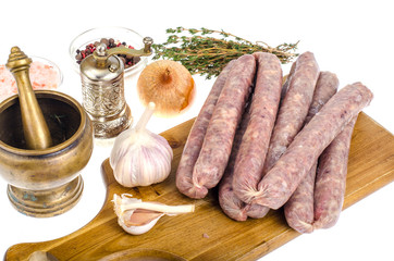 Raw homemade sausage in natural casing, spices, herbs for cooking
