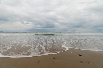 View of the sea from the beach under a stormy sky