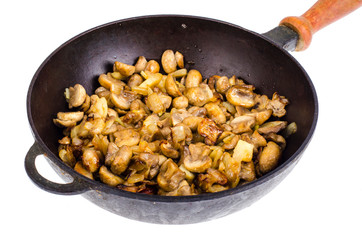 Cast iron pan, fried champignons with onions