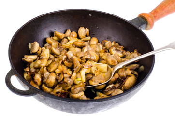 Cast iron pan, fried champignons with onions