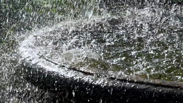 fountain. drops of water fall down. artificial water source. water pipes. a park. heavy rain. super slow motion