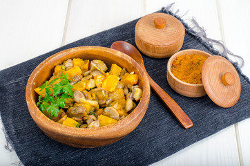 Wooden bowl with vegetable stew with mushrooms