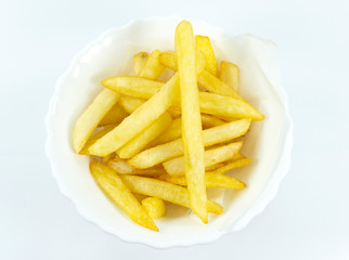 French Fries in a white dish on white background, Top view..