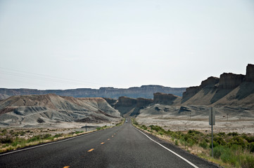 Straight road in white hills in USA