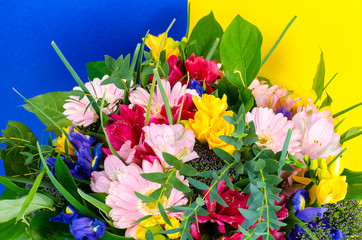 Mix of summer flowers in bouquet on bright background