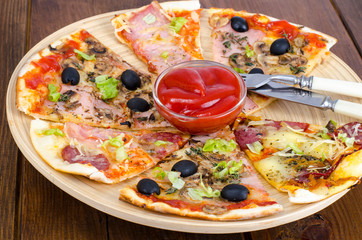 Six slices of pizza with different toppings on wooden board