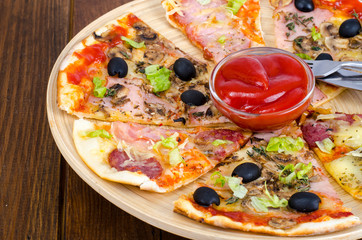 Six slices of pizza with different toppings on wooden board