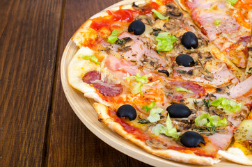 Six slices of pizza with different toppings on wooden board