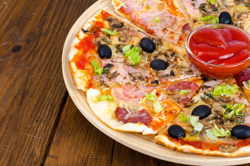 Six slices of pizza with different toppings on wooden board