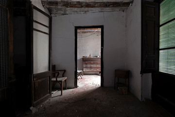 Fototapeta na wymiar Furniture in the gloom of an abandoned house