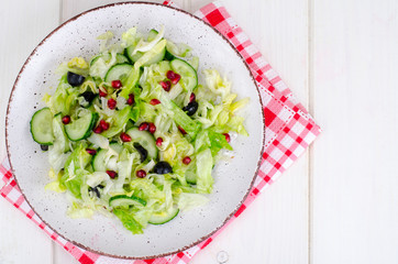 Weight loss. Dietary salad with fresh vegetables and pomegranate seeds