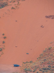 Aerial photo of SUV car at the bottom of sand dune