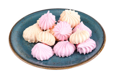 Small colored meringues on white background