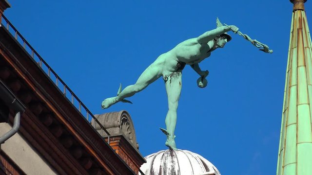 Sculpture of a naked man on the roof of the house. Copenhagen. Denmark. 4K.