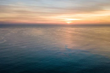 Foto auf Acrylglas Meer / Ozean Sonnenaufgang über dem Ozean