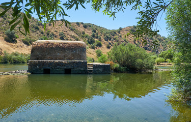 Old traditional watermills in the Guadiana river at Azenhas. Mertola. Portugal © Serg Zastavkin