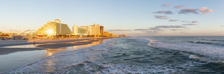 Daytona Beach, Florida, United States - October 31, 2018: Panoramic view of a beautiful sandy beach during a vibrant sunrise.