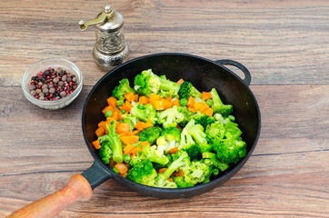 Vegetarian dish. Broccoli, carrots, green peas in pan