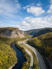 Aerial panoramic view of a scenic road during a vibrant sunny day. Taken near Corner Brook, Newfoundland, Canada.